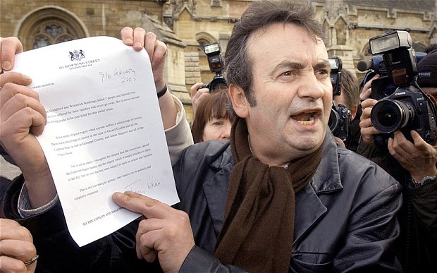 Gerry Conlon showing the letter of apology he received from Tony Blair to media outside the House of Commons in 2005